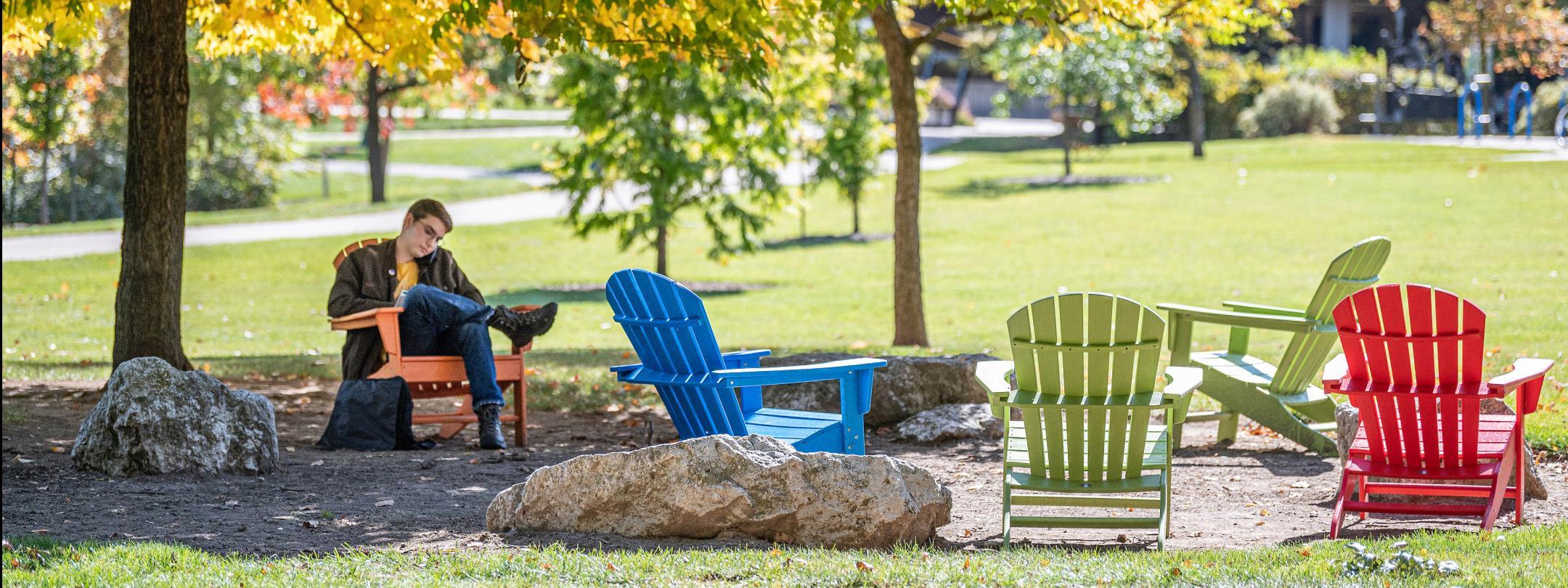 Student studying his class notes outdoors.